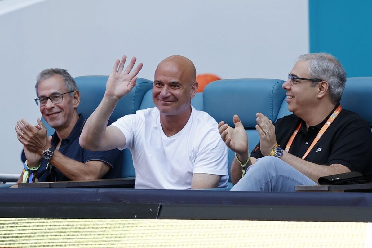 Mar 30, 2024; Miami Gardens, FL, USA; Tennis hall of fame  member Andre Agassi (M) waves to the crowd during a changeover in the match between Elena Rybakina (KAZ) and Danielle Collins (USA) (both not pictured) in the women's singles final of the Miami Open at Hard Rock Stadium. Mandatory Credit: Geoff Burke-USA TODAY Sports