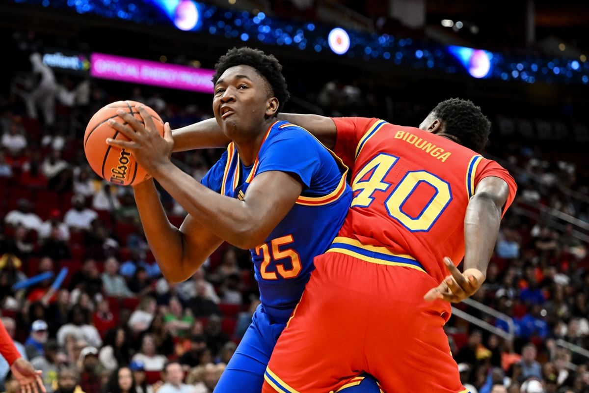 Apr 2, 2024; Houston, TX, USA; McDonald's All American East center Derik Queen (25) drives past McDonald's All American West center Flory Bidunga (40) during the first half at Toyota Center. Mandatory Credit: Maria Lysaker-Imagn Images