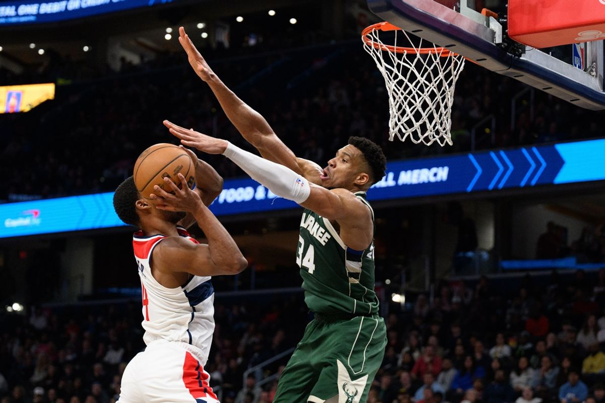 Apr 2, 2024; Washington, District of Columbia, USA; Milwaukee Bucks forward Giannis Antetokounmpo (34) defends against Washington Wizards guard Jared Butler (4) during the fourth quarter at Capital One Arena. Mandatory Credit: Reggie Hildred-Imagn Images