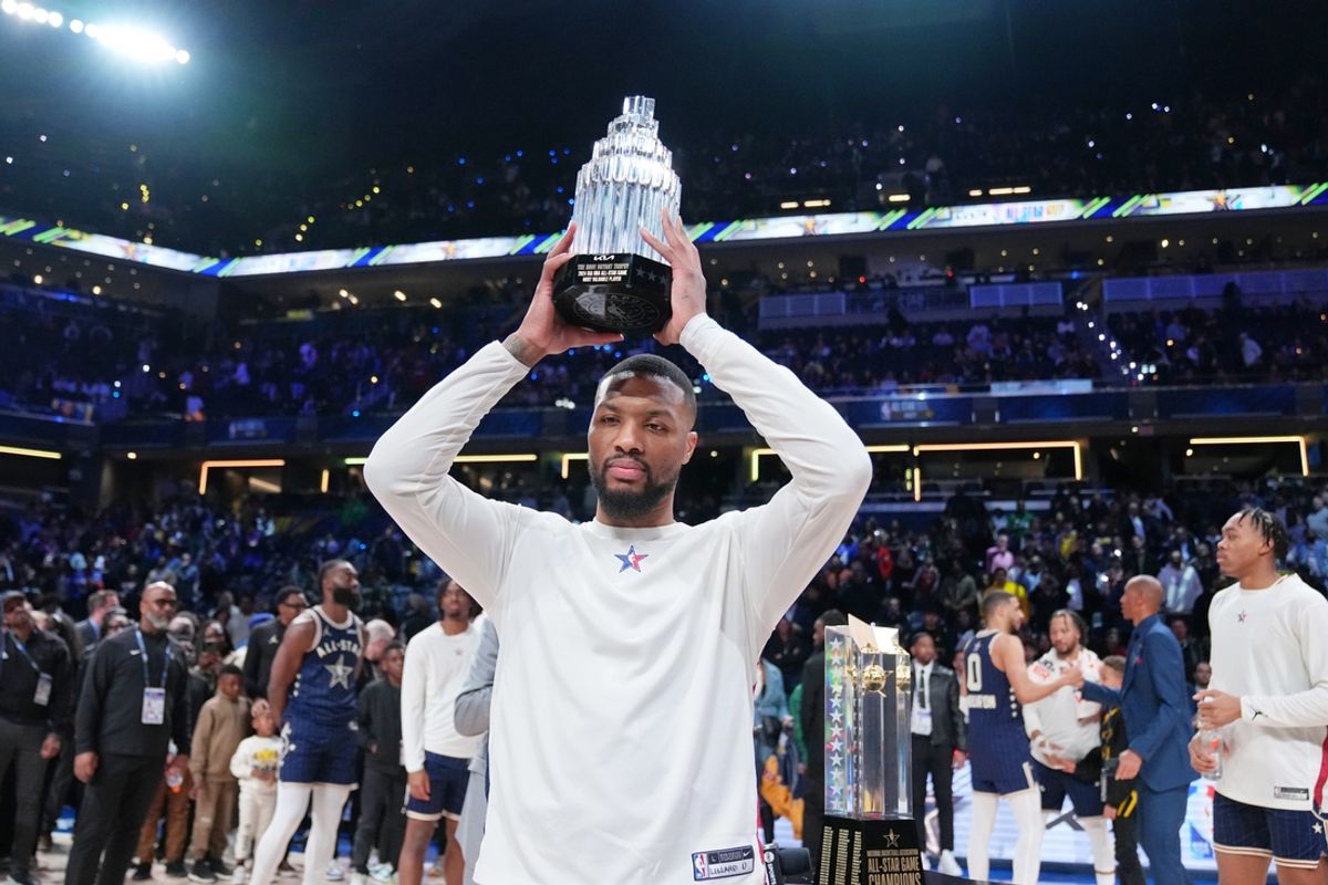 Feb 18, 2024; Indianapolis, Indiana, USA; Eastern Conference guard Damian Lillard (0) of the Milwaukee Bucks holds up the MVP trophy after winning the 73rd NBA All Star game at Gainbridge Fieldhouse. Mandatory Credit: Kyle Terada-Imagn Images