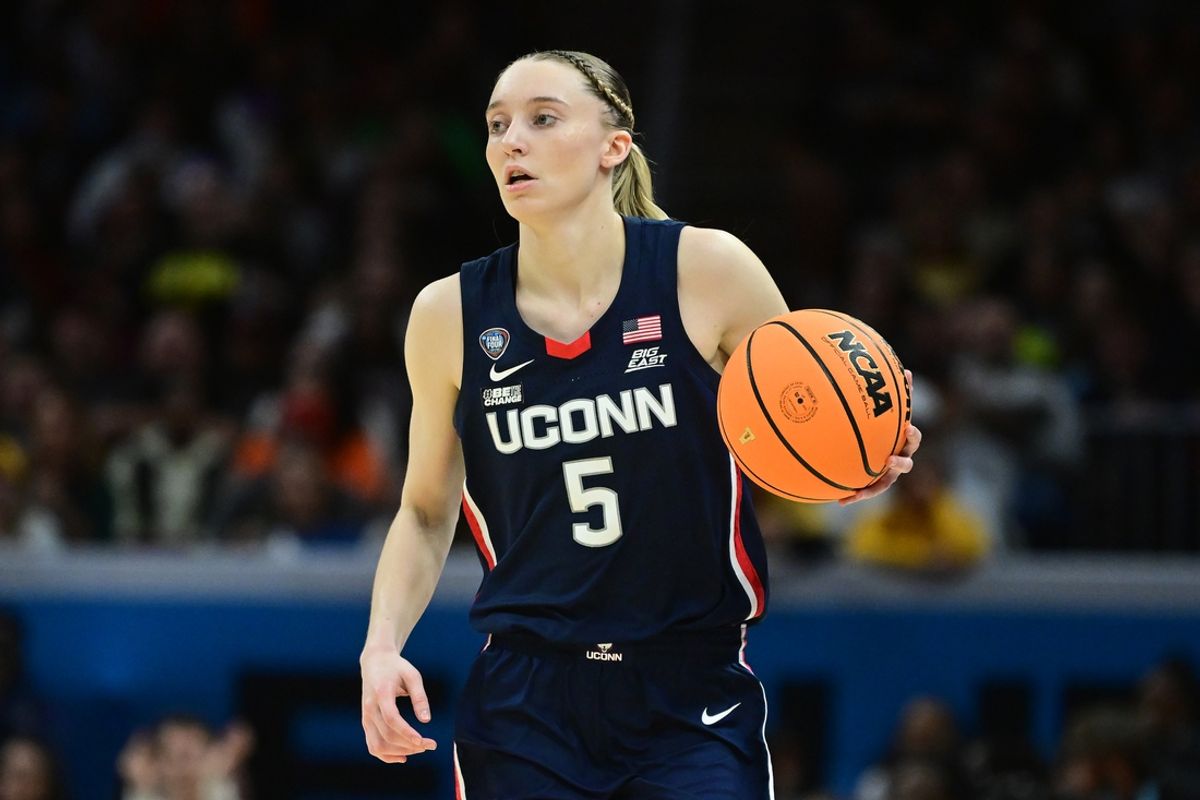 Apr 5, 2024; Cleveland, OH, USA; Connecticut Huskies guard Paige Bueckers (5) dribbles the ball against the Iowa Hawkeyes in the semifinals of the Final Four of the womens 2024 NCAA Tournament at Rocket Mortgage FieldHouse. Mandatory Credit: Ken Blaze-Imagn Images