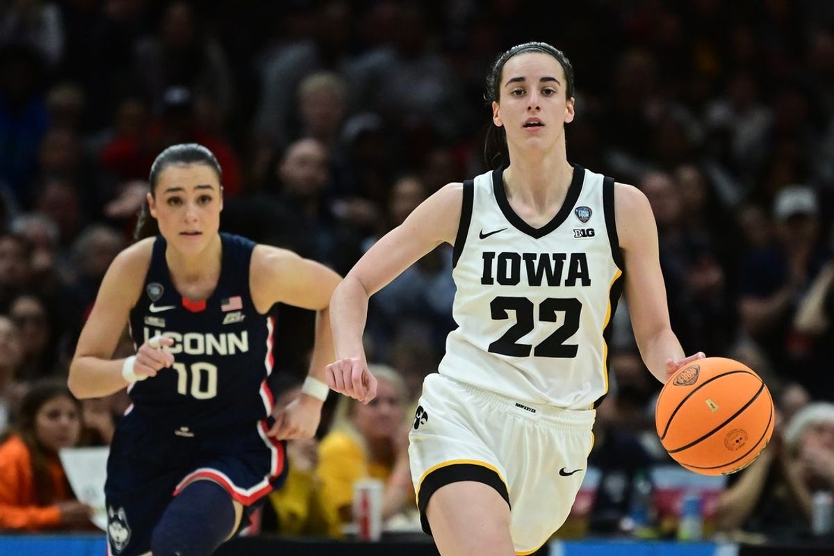 Apr 5, 2024; Cleveland, OH, USA; Iowa Hawkeyes guard Caitlin Clark (22) dribbles the ball past Connecticut Huskies guard Nika Muhl (10) in the semifinals of the Final Four of the womens 2024 NCAA Tournament at Rocket Mortgage FieldHouse. Mandatory Credit: Ken Blaze-Imagn Images