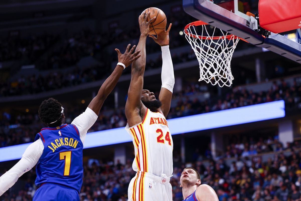 Apr 6, 2024; Denver, Colorado, USA; Atlanta Hawks center Bruno Fernando (24) dunks the ball past Denver Nuggets guard Reggie Jackson (7) in the second half at Ball Arena. Mandatory Credit: Michael Ciaglo-USA TODAY Sports