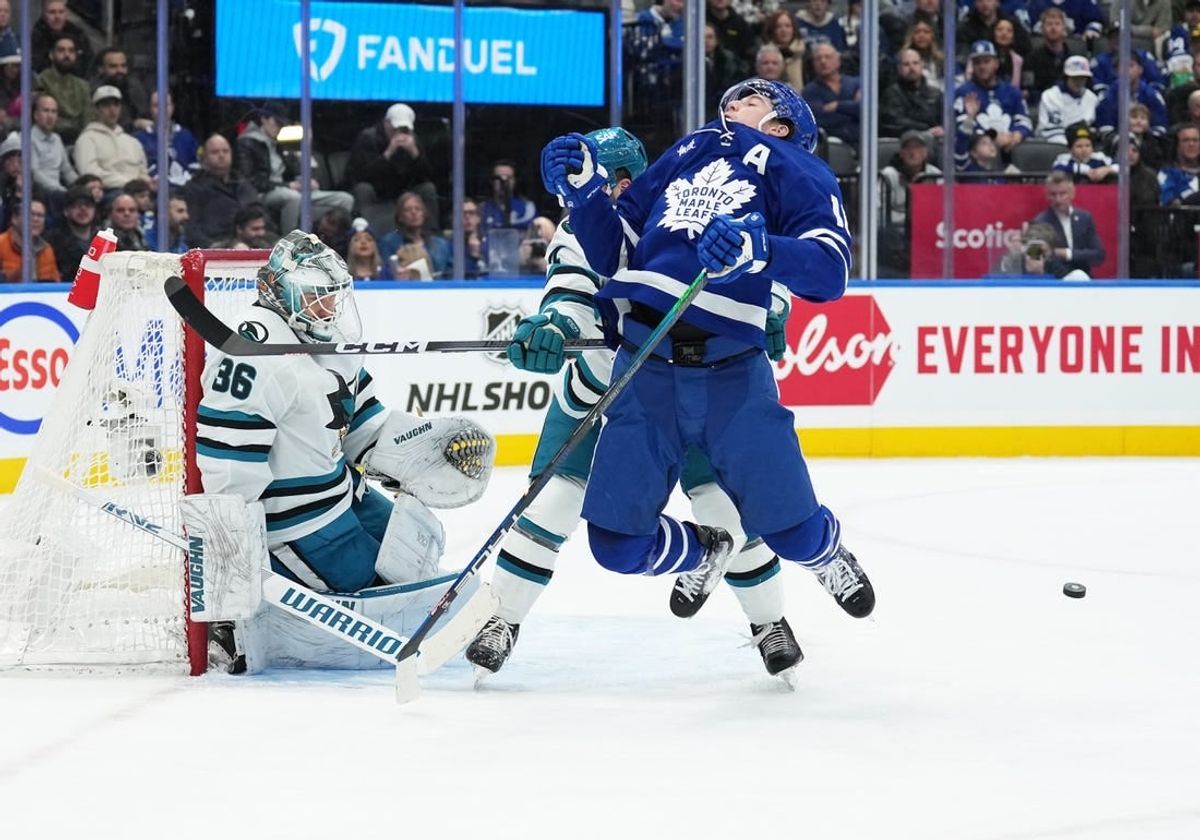 Jan 9, 2024; Toronto, Ontario, CAN; Toronto Maple Leafs right wing Mitchell Marner (16) battles for the puck in front of San Jose Sharks goaltender Kaapo Kahkonen (36) during the first period at Scotiabank Arena.