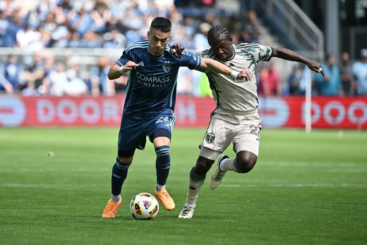 Apr 7, 2024; Kansas City, Kansas, USA; Sporting Kansas City midfielder Erik Thommy (26) and Portland Timbers midfielder Diego Chara (21) battle for the ball during the second half at Children's Mercy Park. Mandatory Credit: Peter Aiken-USA TODAY Sports