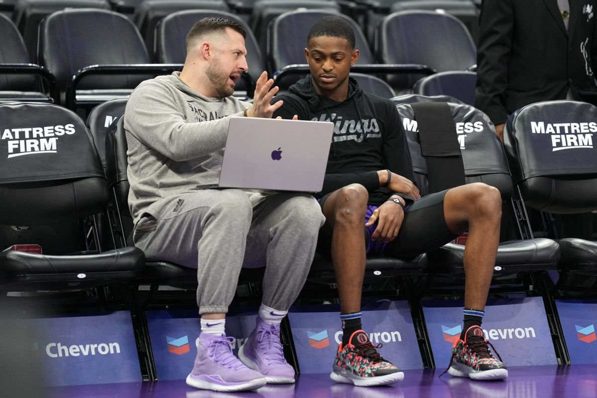 Mar 31, 2024; Sacramento, California, USA; Sacramento Kings assistant coach Luke Loucks (left) talks with guard De'Aaron Fox (right) before the game against the Utah Jazz at Golden 1 Center. Mandatory Credit: Darren Yamashita-Imagn Images