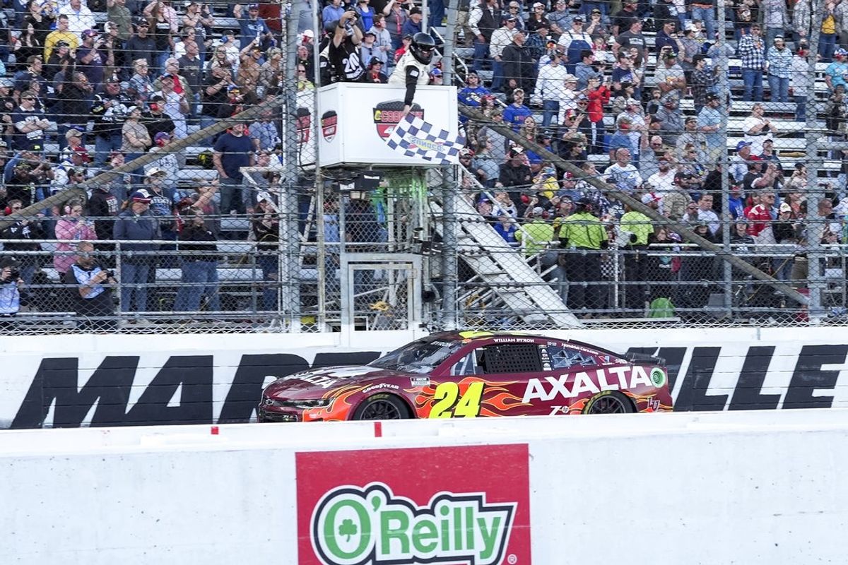 Apr 7, 2024; Martinsville, Virginia, USA; NASCAR Cup Series driver William Byron (24) takes the checkered flag during the Cook Out 400 at Martinsville Speedway. Mandatory Credit: Jim Dedmon-Imagn Images