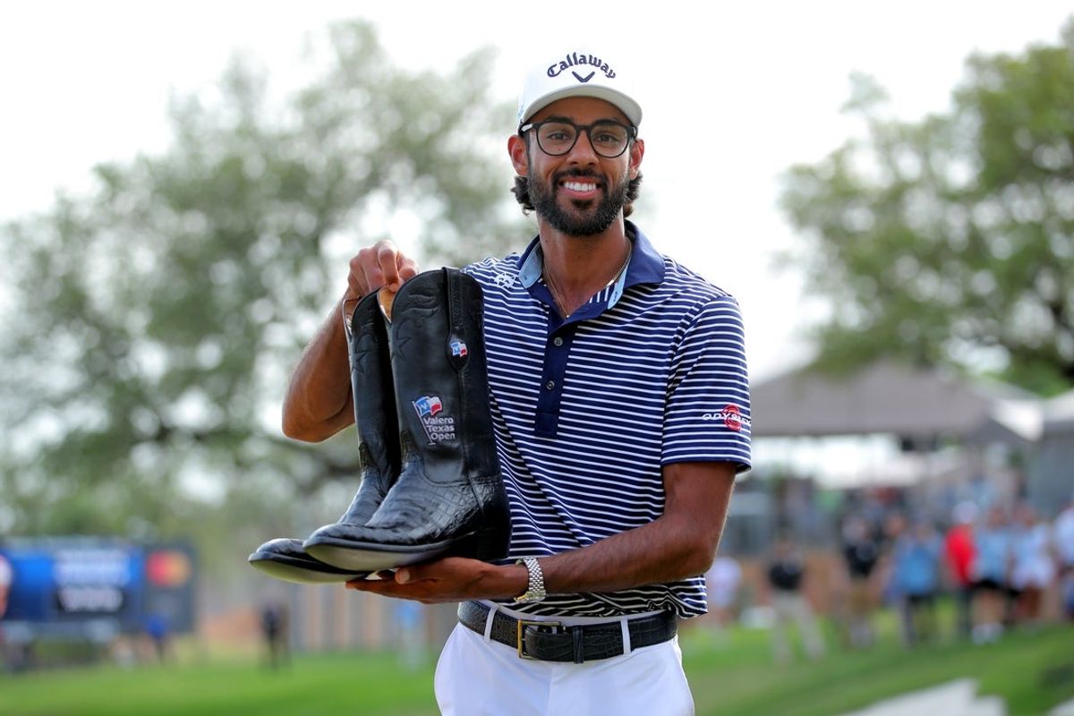 Apr 7, 2024; San Antonio, Texas, USA; Akshay Bhatia poses with a pair of boots after winning the playoff during the final round of the Valero Texas Open golf tournament. Mandatory Credit: Erik Williams-Imagn Images