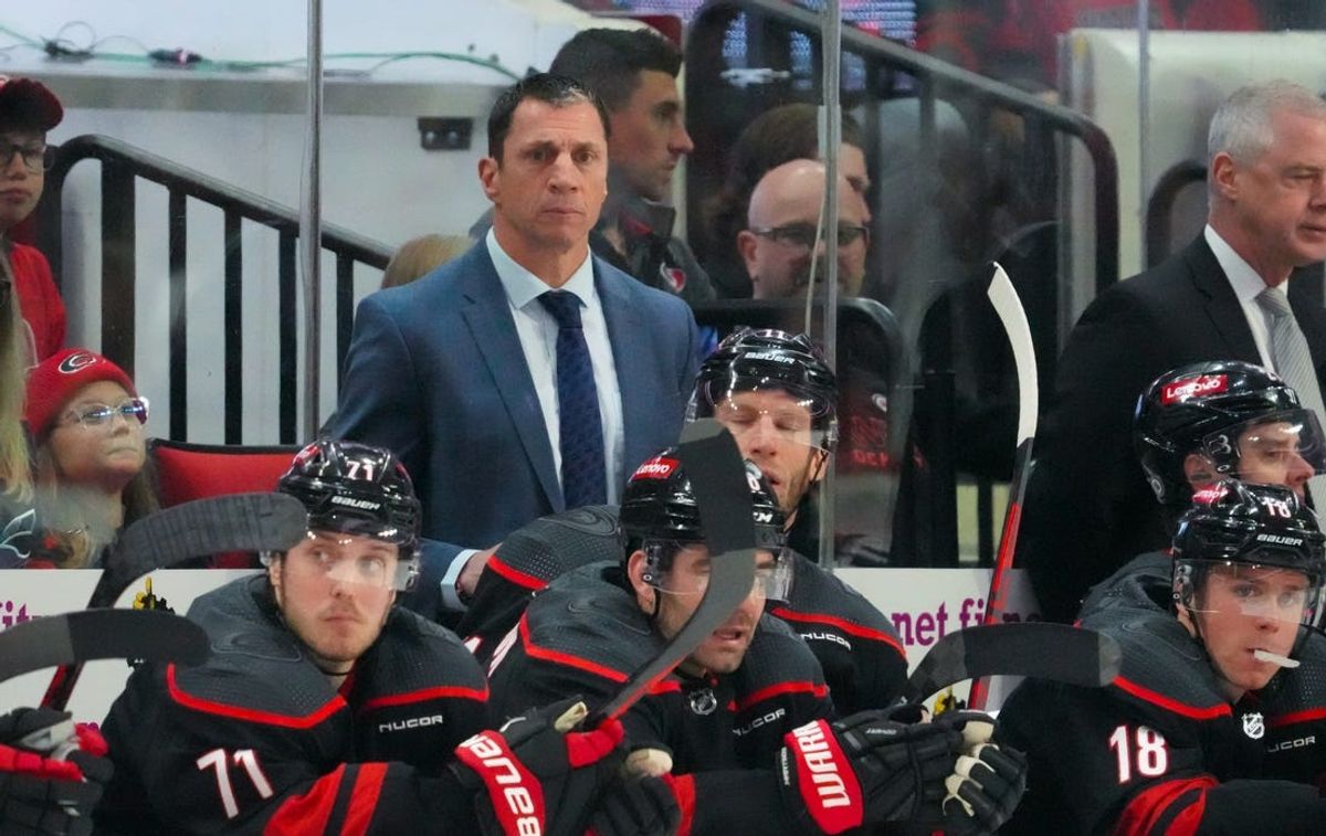 Apr 7, 2024; Raleigh, North Carolina, USA;  Carolina Hurricanes head coach Rod Brind’Amour looks on from behind the players bench against the Columbus Blue Jackets during the second period at PNC Arena. Mandatory Credit: James Guillory-USA TODAY Sports