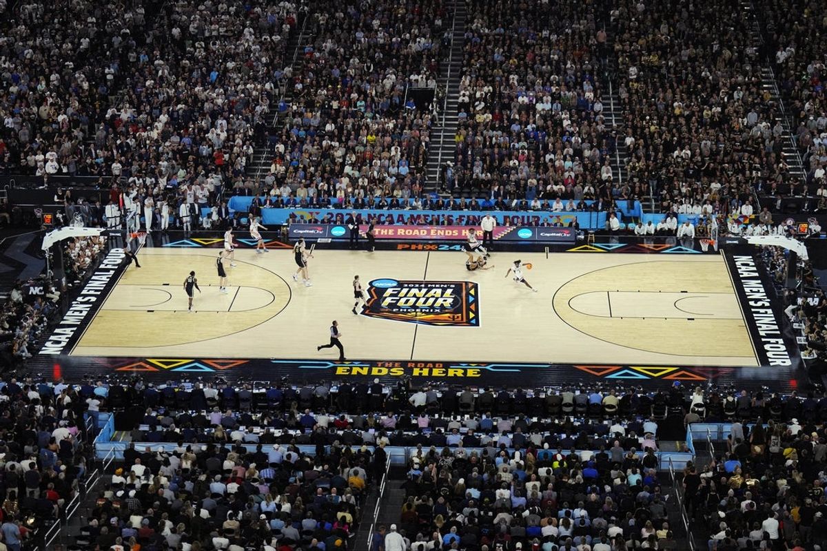Apr 8, 2024; Glendale, AZ, USA;  General view as Connecticut Huskies guard Tristen Newton (2) controls the ball against Purdue Boilermakers forward Trey Kaufman-Renn (4) in the second half in the national championship game of the Final Four of the 2024 NCAA Tournament at State Farm Stadium. Mandatory Credit: Patrick Breen/Arizona Republic-Imagn Images