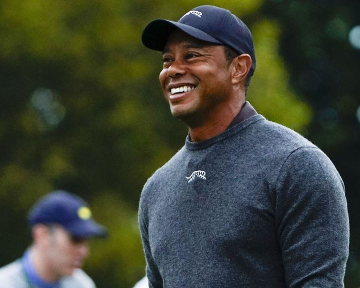 Apr 9, 2024; Augusta, Georgia, USA; Tiger Woods smiles as he walks down the no. 1 fairway during a practice round for the Masters Tournament golf tournament at Augusta National Golf Club. Mandatory Credit: Katie Goodale-USA TODAY Network