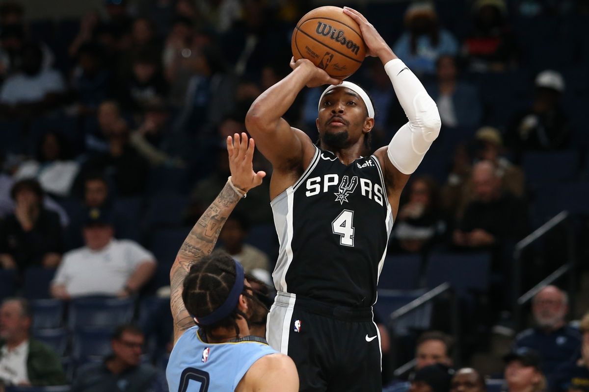 Apr 9, 2024; Memphis, Tennessee, USA; San Antonio Spurs guard Devonte' Graham (4) shoots during the second half against the Memphis Grizzlies at FedExForum. Mandatory Credit: Petre Thomas-USA TODAY Sports