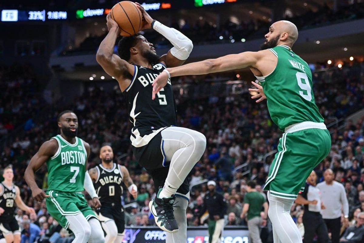 Apr 9, 2024; Milwaukee, Wisconsin, USA;  Milwaukee Bucks guard Malik Beasley (5) takes a shot against Boston Celtics guard Derrick White (9) in the second quarter at Fiserv Forum. Mandatory Credit: Benny Sieu-USA TODAY Sports
