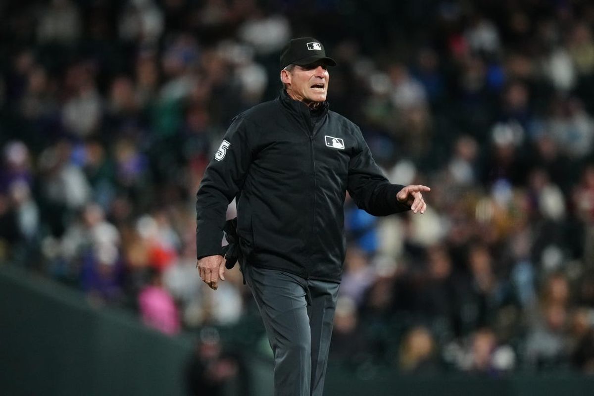 Apr 9, 2024; Denver, Colorado, USA; MLB umpire Angel Hernandez (5) calls out during the game between the Arizona Diamondbacks against the Colorado Rockies at Coors Field. Mandatory Credit: Ron Chenoy-USA TODAY Sports