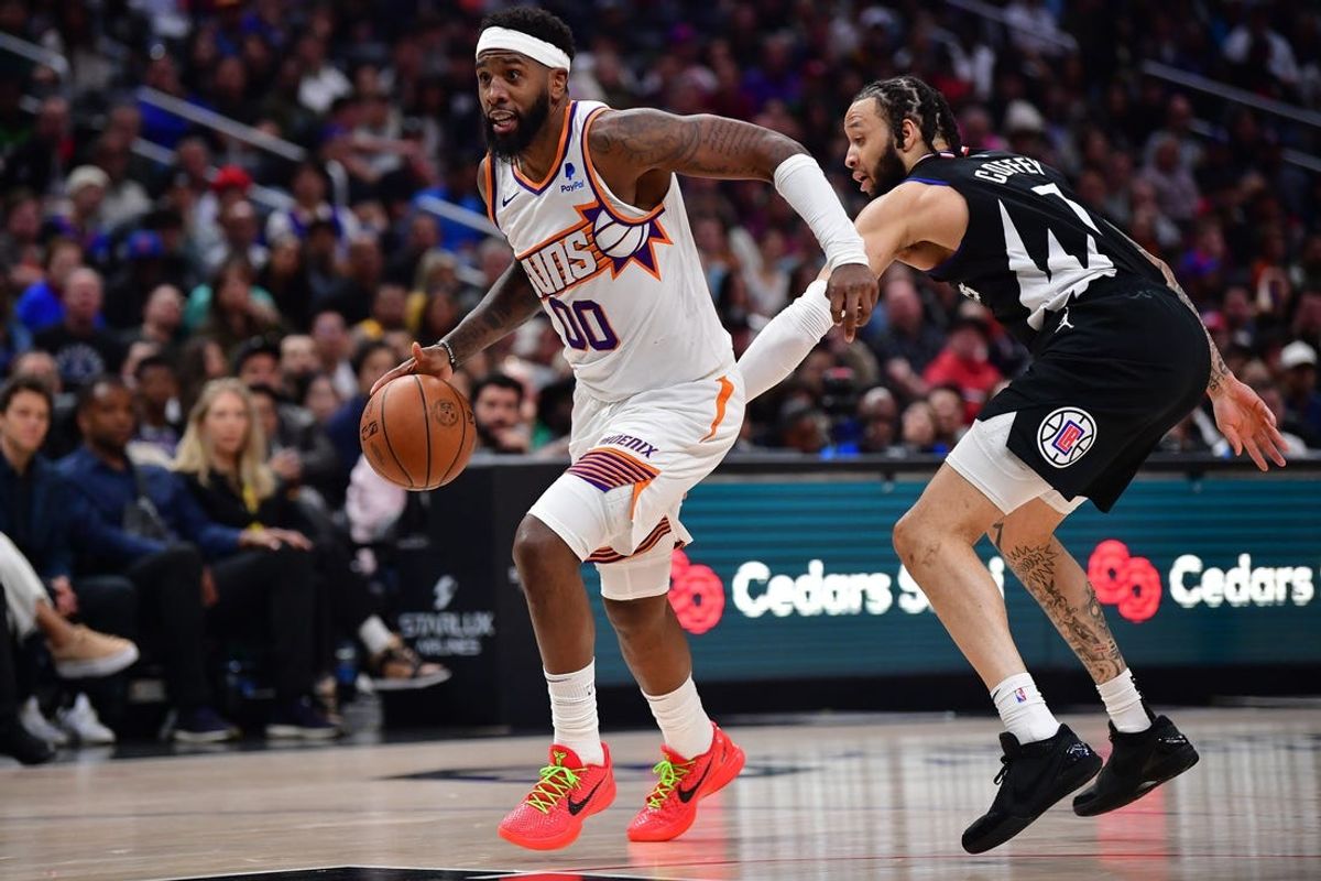Apr 10, 2024; Los Angeles, California, USA; Phoenix Suns forward Royce O'Neale (00) moves the ball against Los Angeles Clippers guard Amir Coffey (7) during the second half at Crypto.com Arena. Mandatory Credit: Gary A. Vasquez-USA TODAY Sports