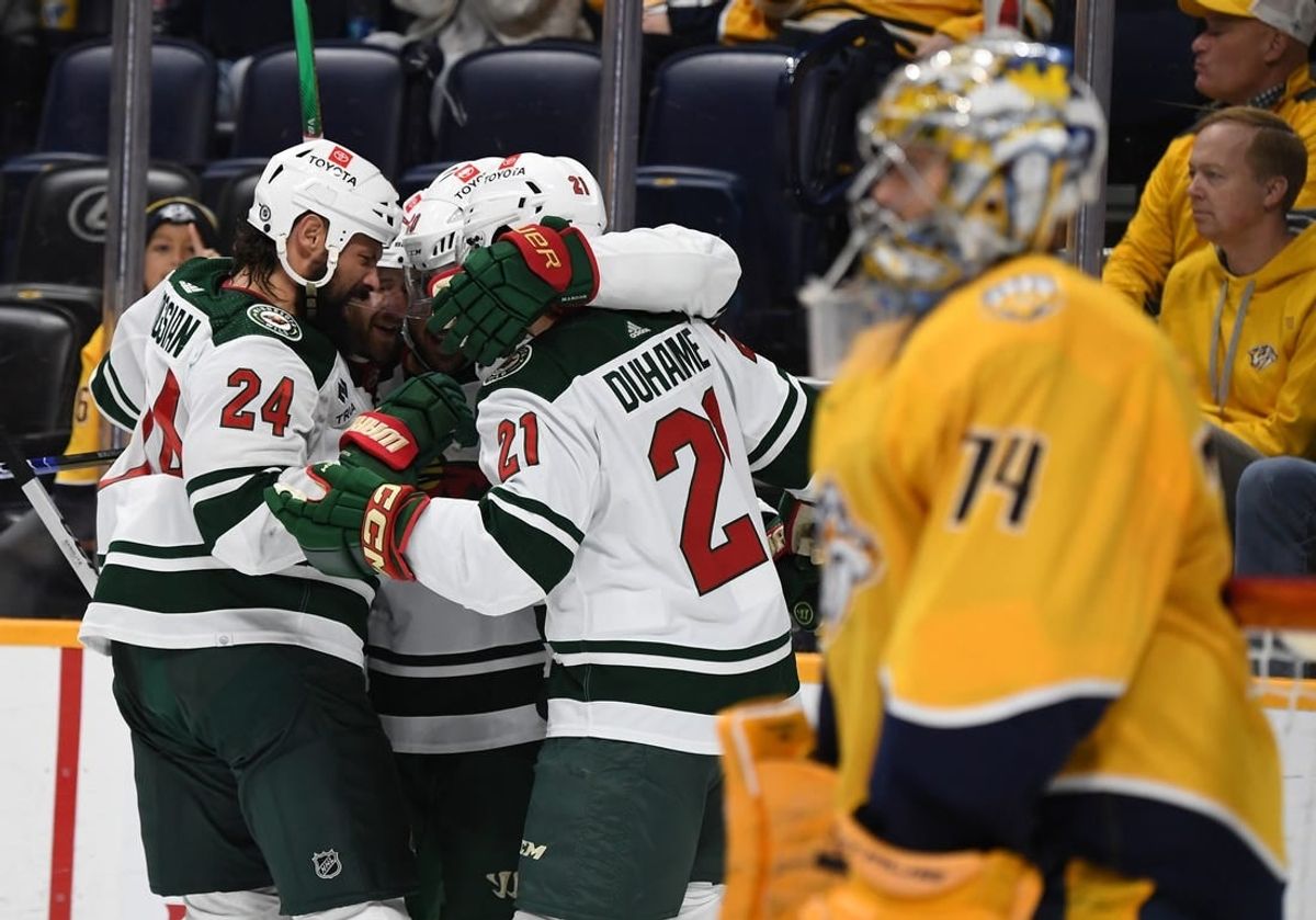 Nov 30, 2023; Nashville, Tennessee, USA; Minnesota Wild players celebrate after a goal by left wing Pat Maroon (20) against Nashville Predators goaltender Juuse Saros (74) during the second period at Bridgestone Arena.