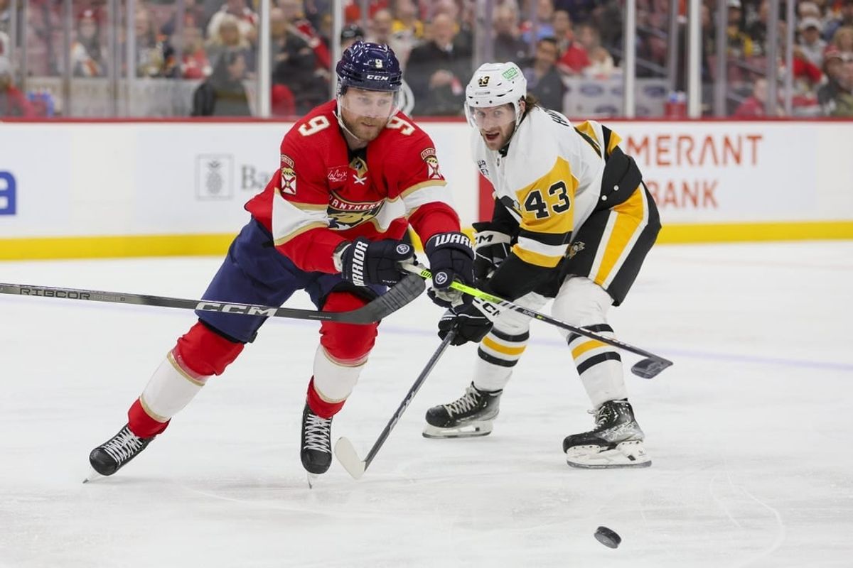 Dec 8, 2023; Sunrise, Florida, USA; Florida Panthers center Sam Bennett (9) protects the puck from Pittsburgh Penguins center Jansen Harkins (43) during the second period at Amerant Bank Arena.