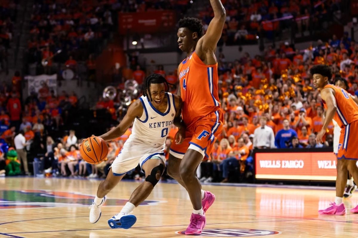 Jan 6, 2024; Gainesville, Florida, USA; Kentucky Wildcats guard Rob Dillingham (0) moves to the basket against Florida Gators forward Tyrese Samuel (4) during the first half at Exactech Arena at the Stephen C. O'Connell Center.