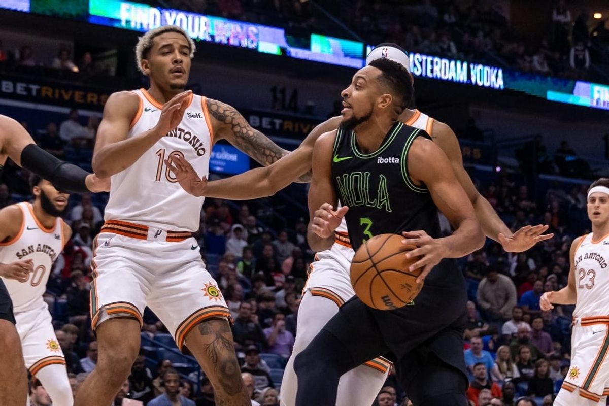 Dec 1, 2023; New Orleans, Louisiana, USA; New Orleans Pelicans guard CJ McCollum (3) dribbles against San Antonio Spurs guard Malaki Branham (22) during the first half at the Smoothie King Center.