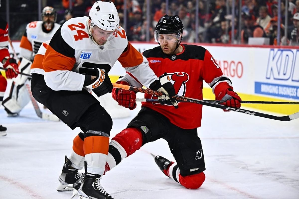 Apr 13, 2024; Philadelphia, Pennsylvania, USA; New Jersey Devils center Chris Tierney (11) and Philadelphia Flyers defenseman Nick Seeler (24) battle for the puck in the second period at Wells Fargo Center.
