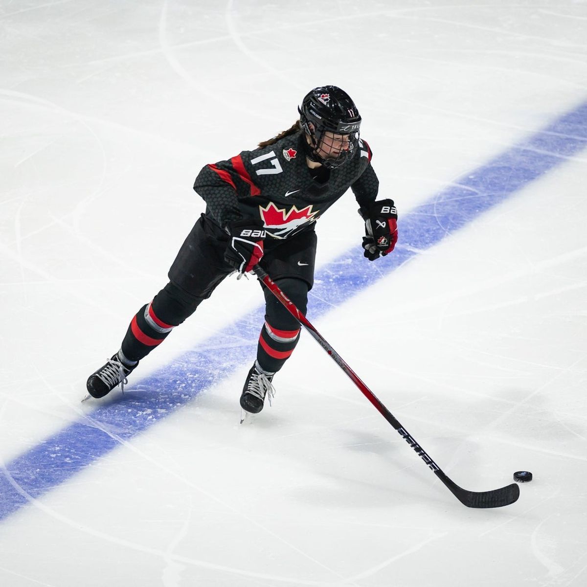 Canada's Ella Shelton carries the puck at the Adirondack Bank Center in Utica, NY on Thursday, April 11, 2024.