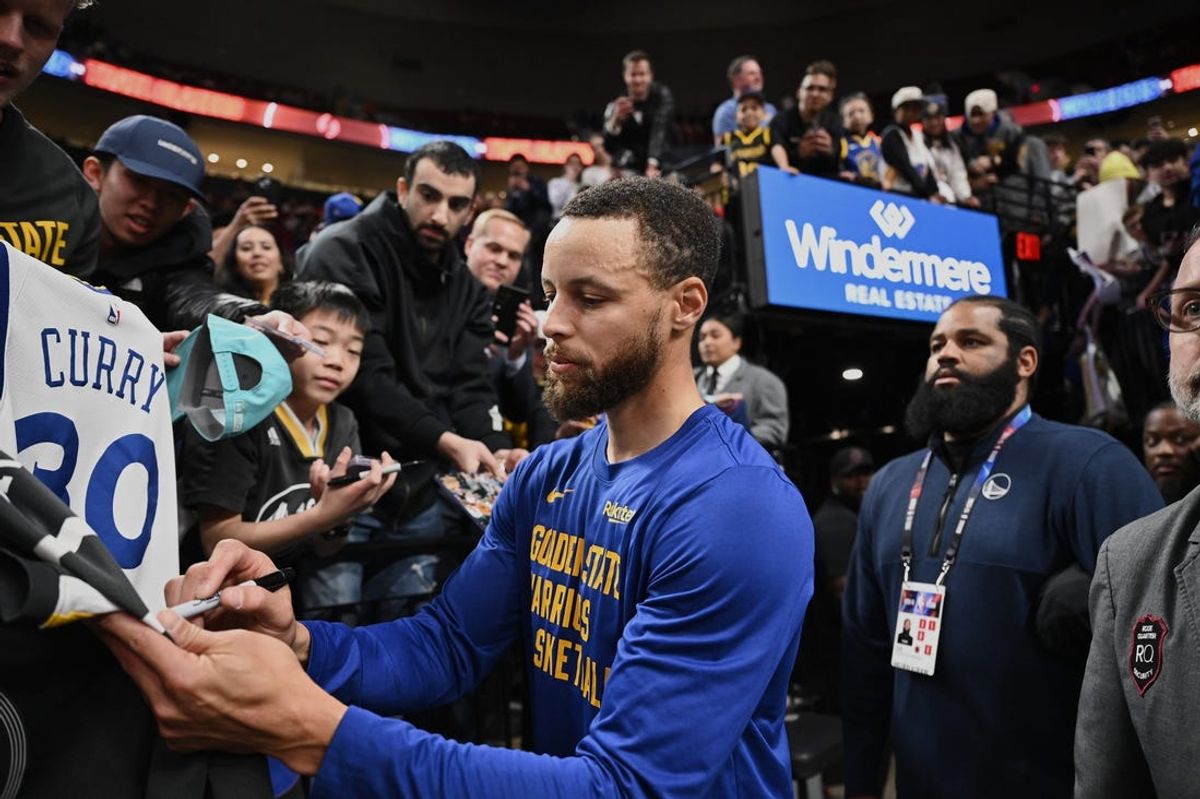 Apr 11, 2024; Portland, Oregon, USA; Golden State Warriors guard Stephen Curry (30) signs autographs for fans before a game against the Portland Trail Blazers at Moda Center. Mandatory Credit: Troy Wayrynen-USA TODAY Sports