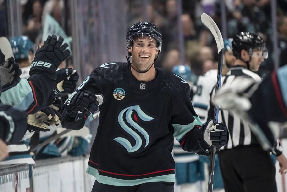 Apr 11, 2024; Seattle, Washington, USA; Seattle Kraken defenseman Brian Dumoulin (8) celebrates with teammates on the bench after scoring a goal against the San Jose Sharks during the first period at Climate Pledge Arena. Mandatory Credit: Stephen Brashear-USA TODAY Sports