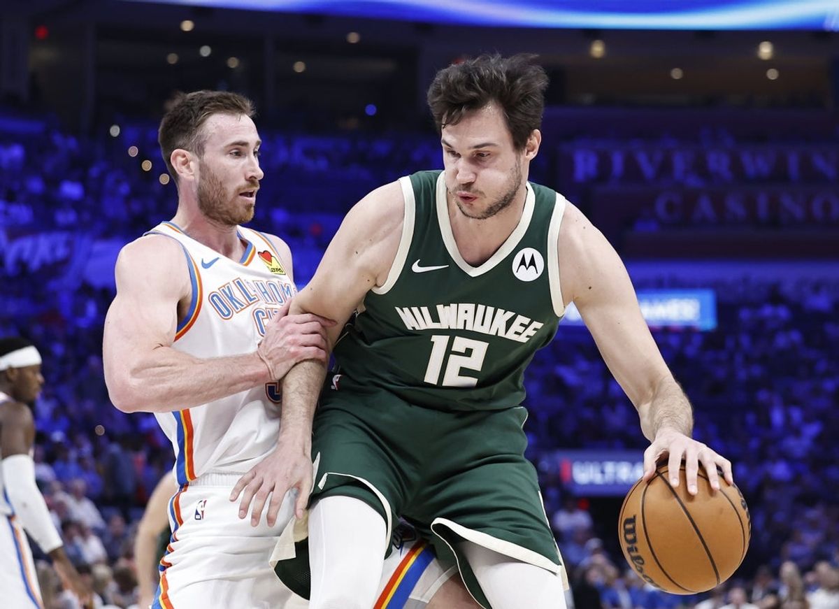 Apr 12, 2024; Oklahoma City, Oklahoma, USA; Milwaukee Bucks forward Danilo Gallinari (12) is defended by Oklahoma City Thunder guard Cason Wallace (22) during the second quarter at Paycom Center. Mandatory Credit: Alonzo Adams-Imagn Images