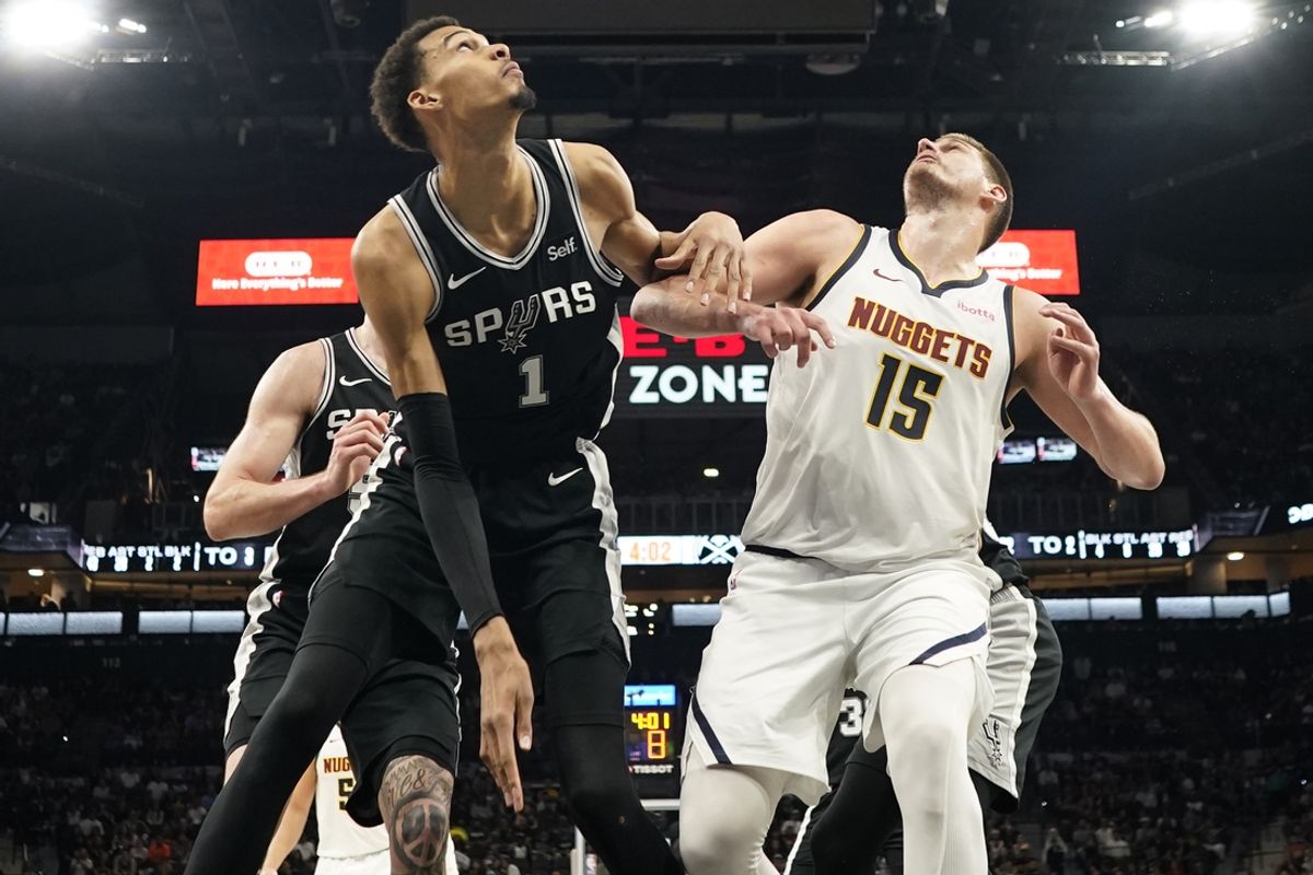 Apr 12, 2024; San Antonio, Texas, USA; Denver Nuggets center Nikola Jokic (15) and San Antonio Spurs forward Victor Wembanyama (1) box out for a rebound during the second half at Frost Bank Center. Mandatory Credit: Scott Wachter-Imagn Images