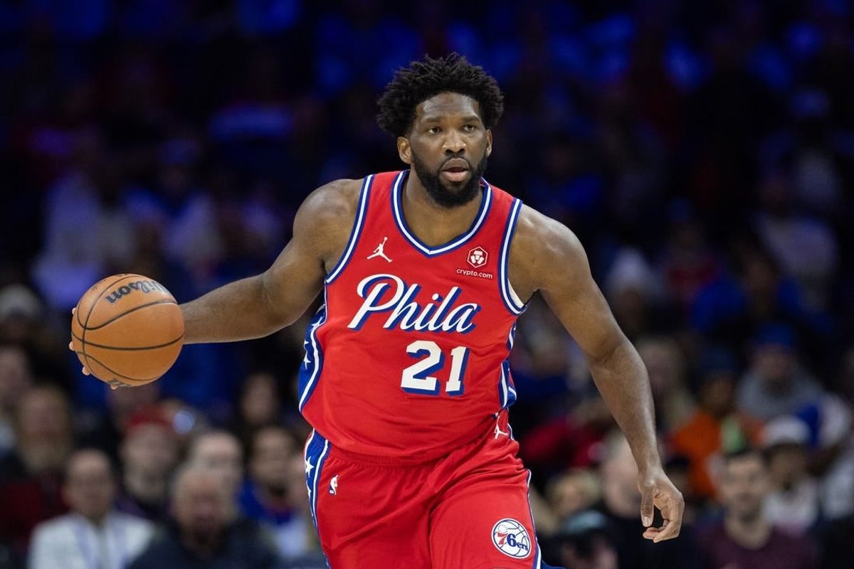 Dec 15, 2023; Philadelphia, Pennsylvania, USA; Philadelphia 76ers center Joel Embiid (21) dribbles up court against the Detroit Pistons during the first quarter at Wells Fargo Center.