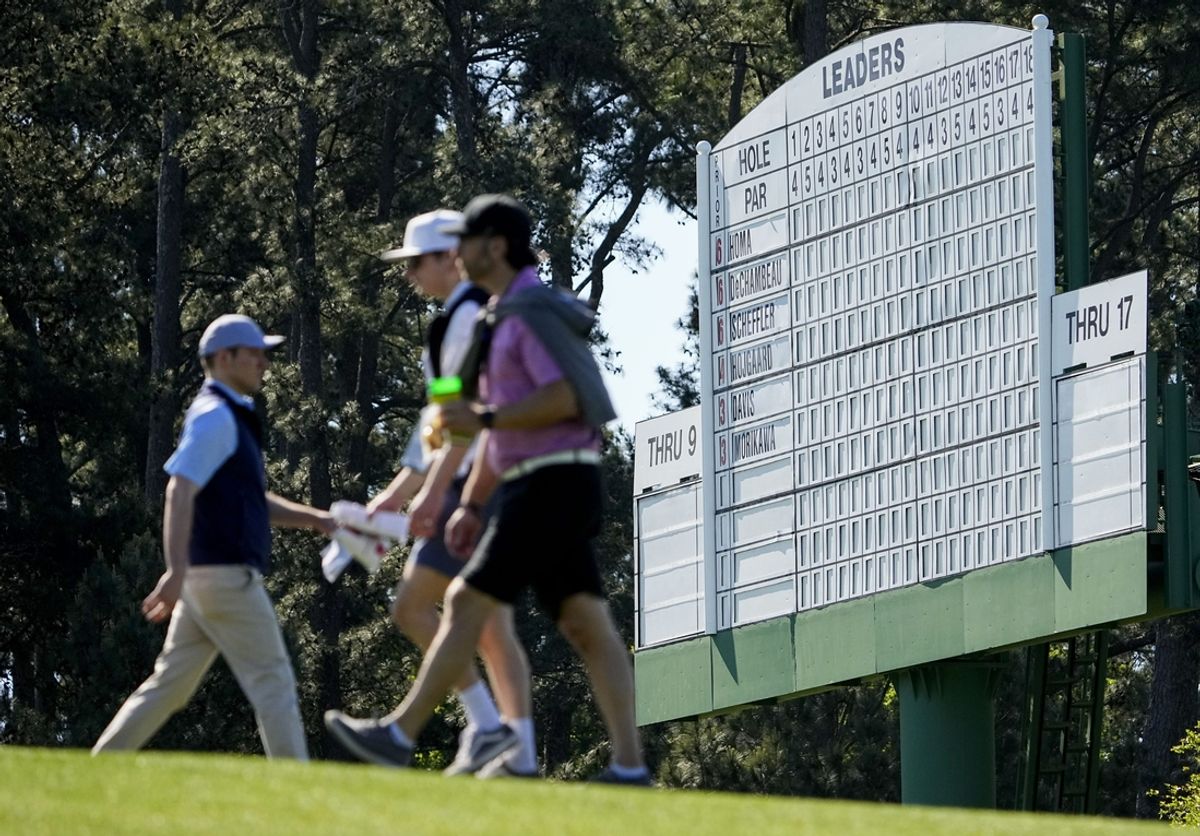 Apr 13, 2024; Augusta, Georgia, USA; Patrons move past the no. 18 leaderboard during the third round of the Masters Tournament. Mandatory Credit: Adam Cairns-USA TODAY Network