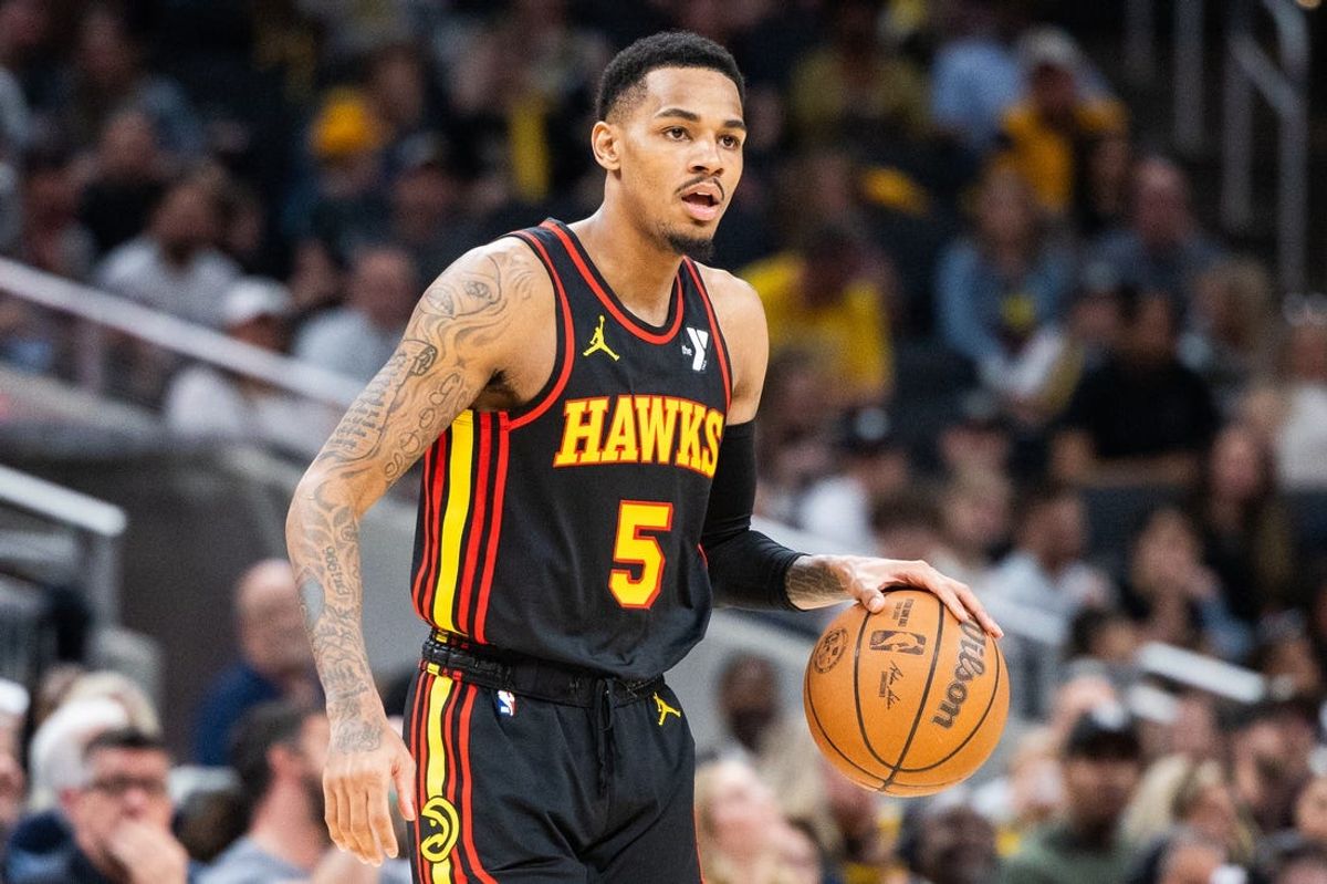 Apr 14, 2024; Indianapolis, Indiana, USA; Atlanta Hawks guard Dejounte Murray (5) dribbles the ball while Indiana Pacers guard Ben Sheppard (26) defends in the second half at Gainbridge Fieldhouse. Mandatory Credit: Trevor Ruszkowski-USA TODAY Sports