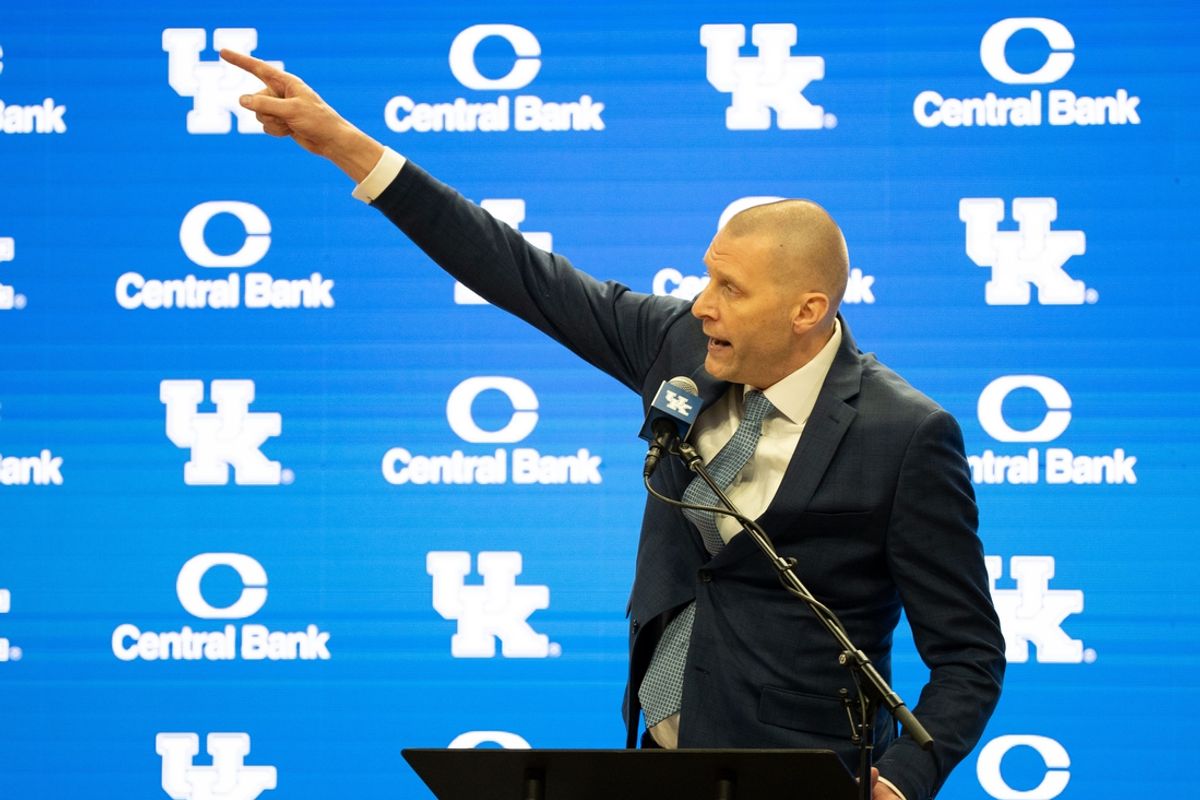 University of Kentucky’s new men’s basketball coach Mark Pope points to the championship banners as he speaks about the victories he will soon be adding to display.