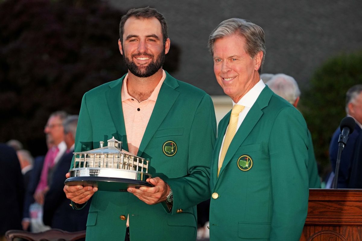 Apr 14, 2024; Augusta, Georgia, USA; Scottie Scheffler poses with The Masters trophy and Augusta National Golf Club chairperson Fred Ridley after the final round of the Masters Tournament. Mandatory Credit: Kyle Terada-Imagn Images