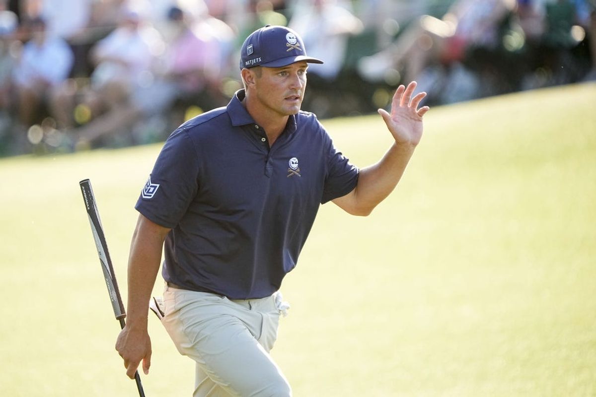 Apr 14, 2024; Augusta, Georgia, USA; Bryson DeChambeau waves to patrons as he walks up to the No. 18 green during the final round of the Masters Tournament. Mandatory Credit: Adam Cairns-USA TODAY Network