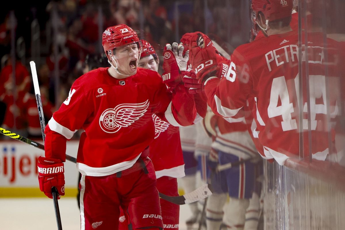 Apr 15, 2024; Detroit, Michigan, USA;  Detroit Red Wings left wing Lucas Raymond (23) receives congratulations from teammates after scoring in the third period against the Montreal Canadiens at Little Caesars Arena. Mandatory Credit: Rick Osentoski-Imagn Images