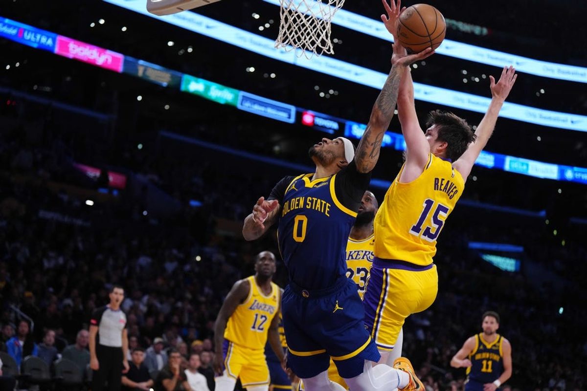 Apr 9, 2024; Los Angeles, California, USA; Golden State Warriors guard Gary Payton II (0) shoots the ball against Los Angeles Lakers guard Austin Reaves (15) in the second half at Crypto.com Arena. Mandatory Credit: Kirby Lee-USA TODAY Sports