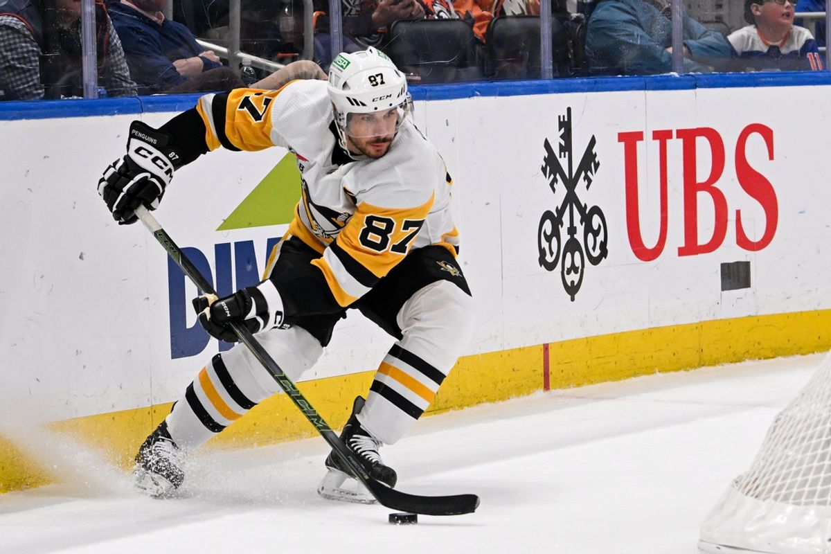 Apr 17, 2024; Elmont, New York, USA;  Pittsburgh Penguins center Sidney Crosby (87) controls the puck behind the net against the New York Islanders during the first period at UBS Arena. Mandatory Credit: Dennis Schneidler-Imagn Images