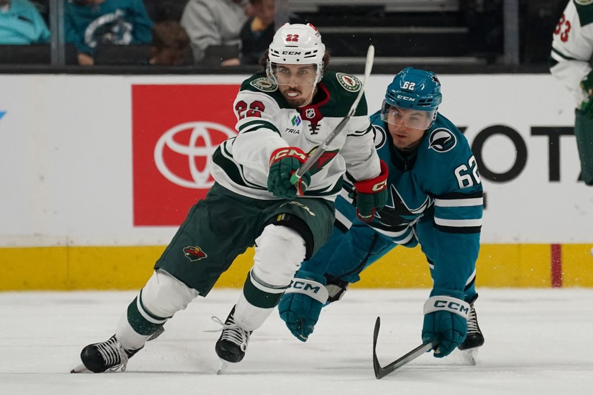 Apr 13, 2024; San Jose, California, USA; Minnesota Wild center Marat Khusnutdinov (22) battles San Jose Sharks right wing Kevin Labanc (62) for the puck during the third period at SAP Center at San Jose. Mandatory Credit: David Gonzales-Imagn Images