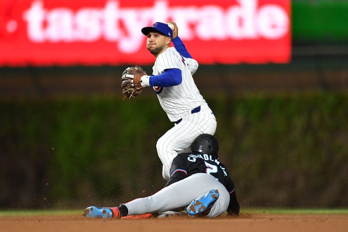 Apr 20, 2024; Chicago, Illinois, USA; Chicago Cubs third baseman Nick Madrigal (1) completes a double play after forcing out Miami Marlins outfielder Jazz Chisholm Jr. (2) during the fourth inning at Wrigley Field. Mandatory Credit: Patrick Gorski-USA TODAY Sports