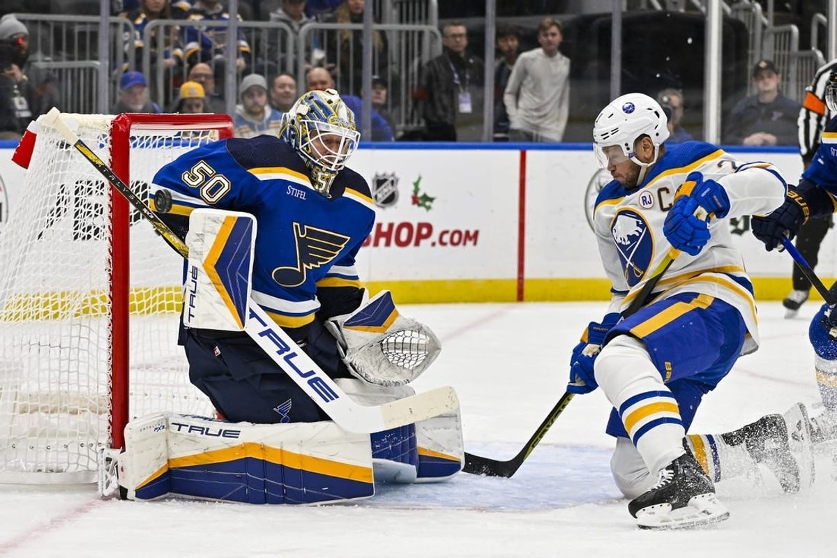 Nov 30, 2023; St. Louis, Missouri, USA;  St. Louis Blues goaltender Jordan Binnington (50) makes a save against Buffalo Sabres right wing Kyle Okposo (21) during the first period at Enterprise Center.