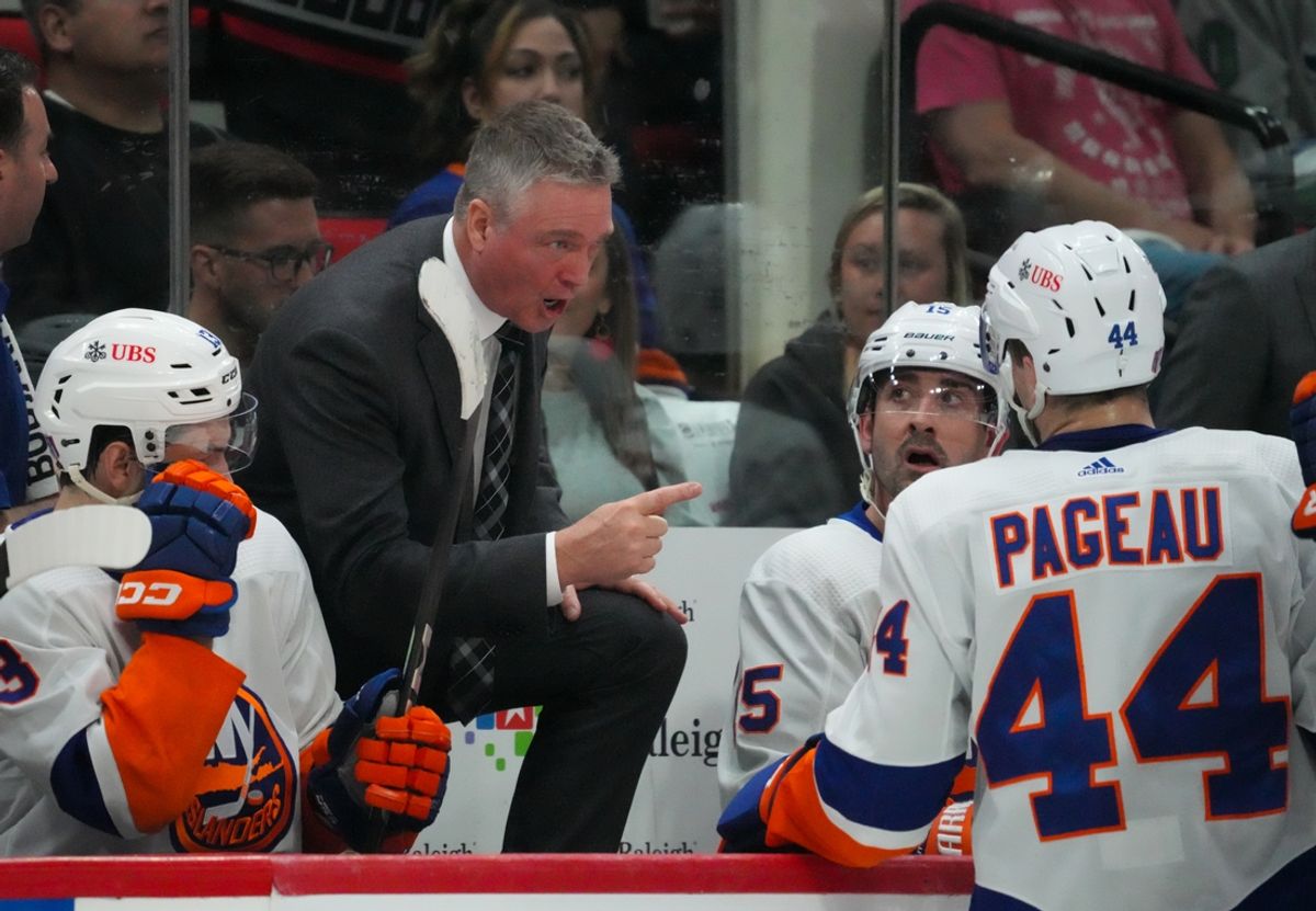 Apr 22, 2024; Raleigh, North Carolina, USA; New York Islanders head coach Patrick Roy talks to center Jean-Gabriel Pageau (44) and right wing Cal Clutterbuck (15) against the Carolina Hurricanes during the second period in game two of the first round of the 2024 Stanley Cup Playoffs at PNC Arena. Mandatory Credit: James Guillory-Imagn Images