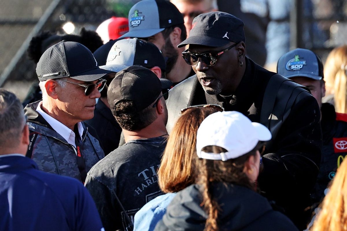 Apr 21, 2024; Talladega, Alabama, USA; NASCAR team owner Michael Jordan and Film producer Curtis Polk talk to NASCAR Cup Series driver Bubba Wallace (23) in victory lane after the GEICO 500 at Talladega Superspeedway. Mandatory Credit: Peter Casey-Imagn Images