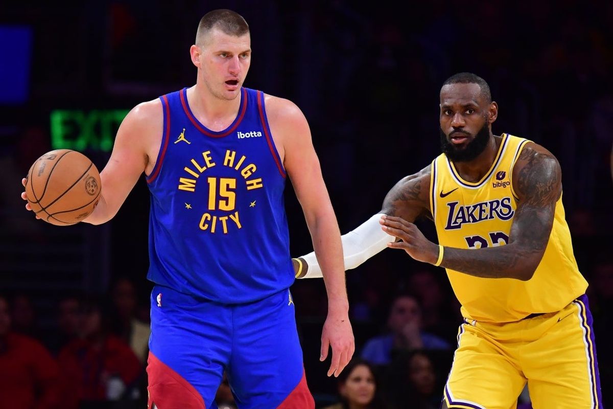 Apr 25, 2024; Los Angeles, California, USA; Denver Nuggets center Nikola Jokic (15) controls the ball against Los Angeles Lakers forward LeBron James (23)  during the second half in game three of the first round for the 2024 NBA playoffs at Crypto.com Arena. Mandatory Credit: Gary A. Vasquez-Imagn Images