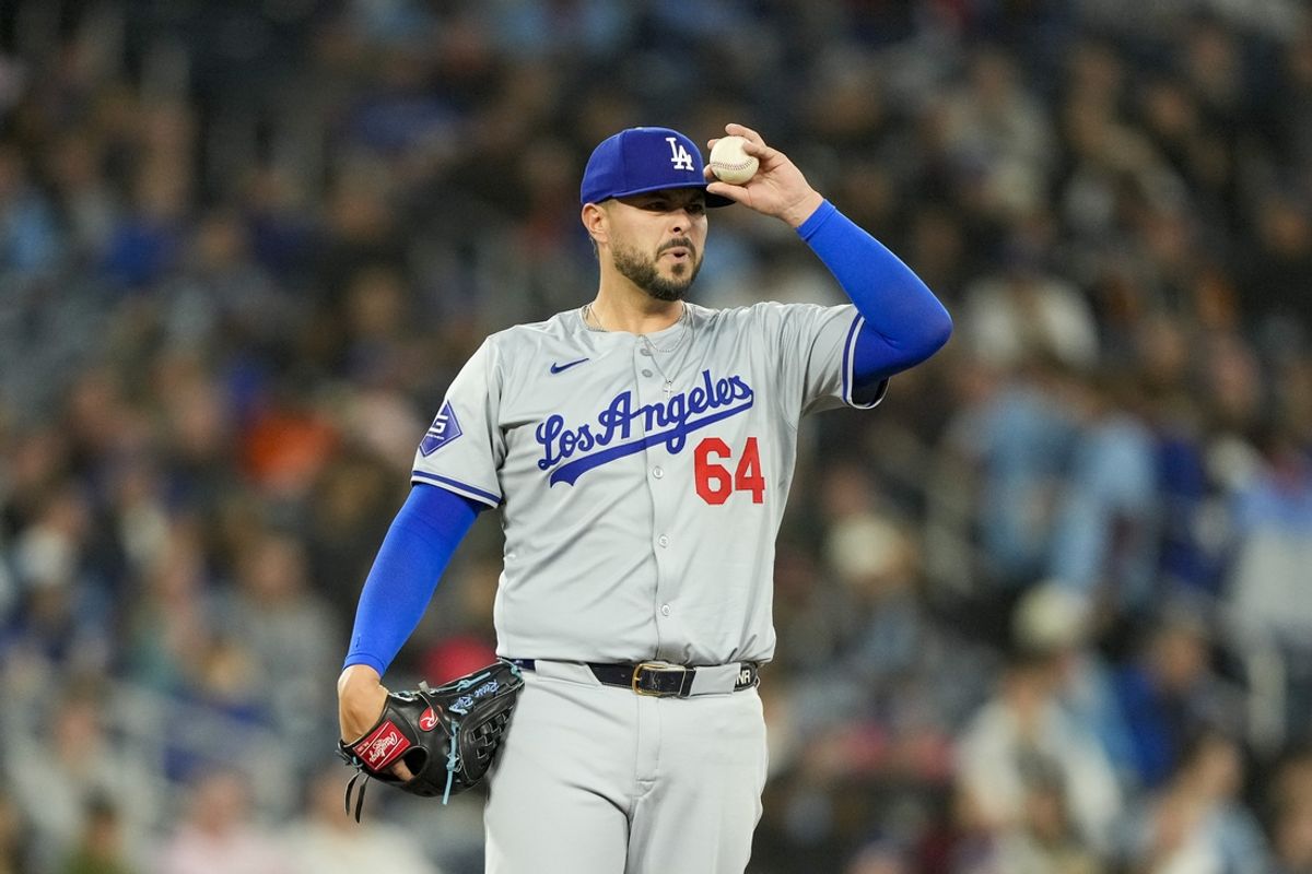 Apr 26, 2024; Toronto, Ontario, CAN; Los Angeles Dodgers pitcher Nick Ramirez (64) adjusts his cap during the ninth inning against the Toronto Blue Jays at Rogers Centre. Mandatory Credit: Kevin Sousa-Imagn Images
