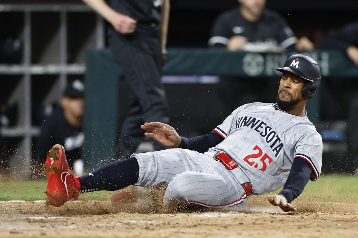 Apr 29, 2024; Chicago, Illinois, USA; Minnesota Twins outfielder Byron Buxton (25) slides to score against the Chicago White Sox during the ninth inning at Guaranteed Rate Field. Mandatory Credit: Kamil Krzaczynski-USA TODAY Sports