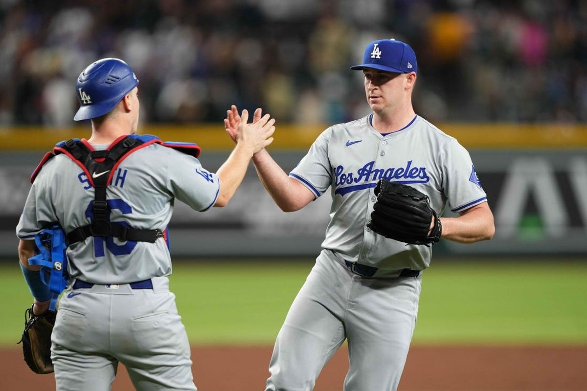 Apr 29, 2024; Phoenix, Arizona, USA; Los Angeles Dodgers catcher Will Smith (16) and Los Angeles Dodgers pitcher Evan Phillips (59) celebrate after defeating the Arizona Diamondbacks at Chase Field. Mandatory Credit: Joe Camporeale-USA TODAY Sports