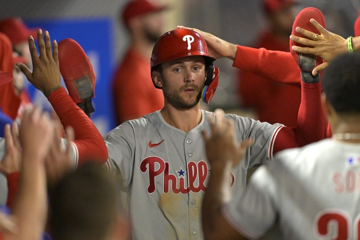 Apr 29, 2024; Anaheim, California, USA; Philadelphia Phillies shortstop Trea Turner (7) is greeted in the dugout after he scored on a sacrifice fly by third baseman Alec Bohm (not pictured) in the ninth inning against the Los Angeles Angels at Angel Stadium. Mandatory Credit: Jayne Kamin-Oncea-USA TODAY Sports