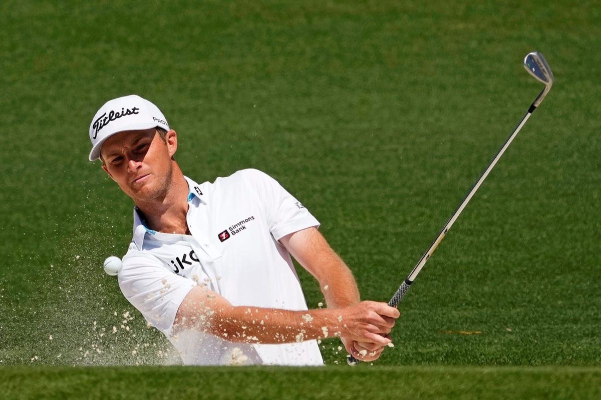 Apr 13, 2024; Augusta, Georgia, USA; Will Zalatoris plays a shot from a bunker on the second hole during the third round of the Masters Tournament.