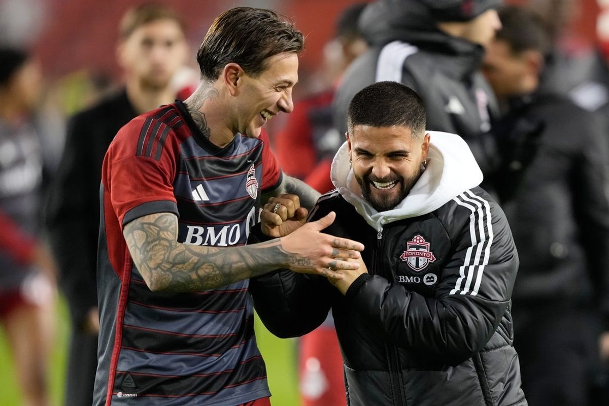 Apr 20, 2024; Toronto, Ontario, CAN; Toronto FC forward Federico Bernardeschi (left) and injured forward Lorenzo Insigne (right) celebrate a win over New England Revolution at BMO Field. Mandatory Credit: John E. Sokolowski-Imagn Images